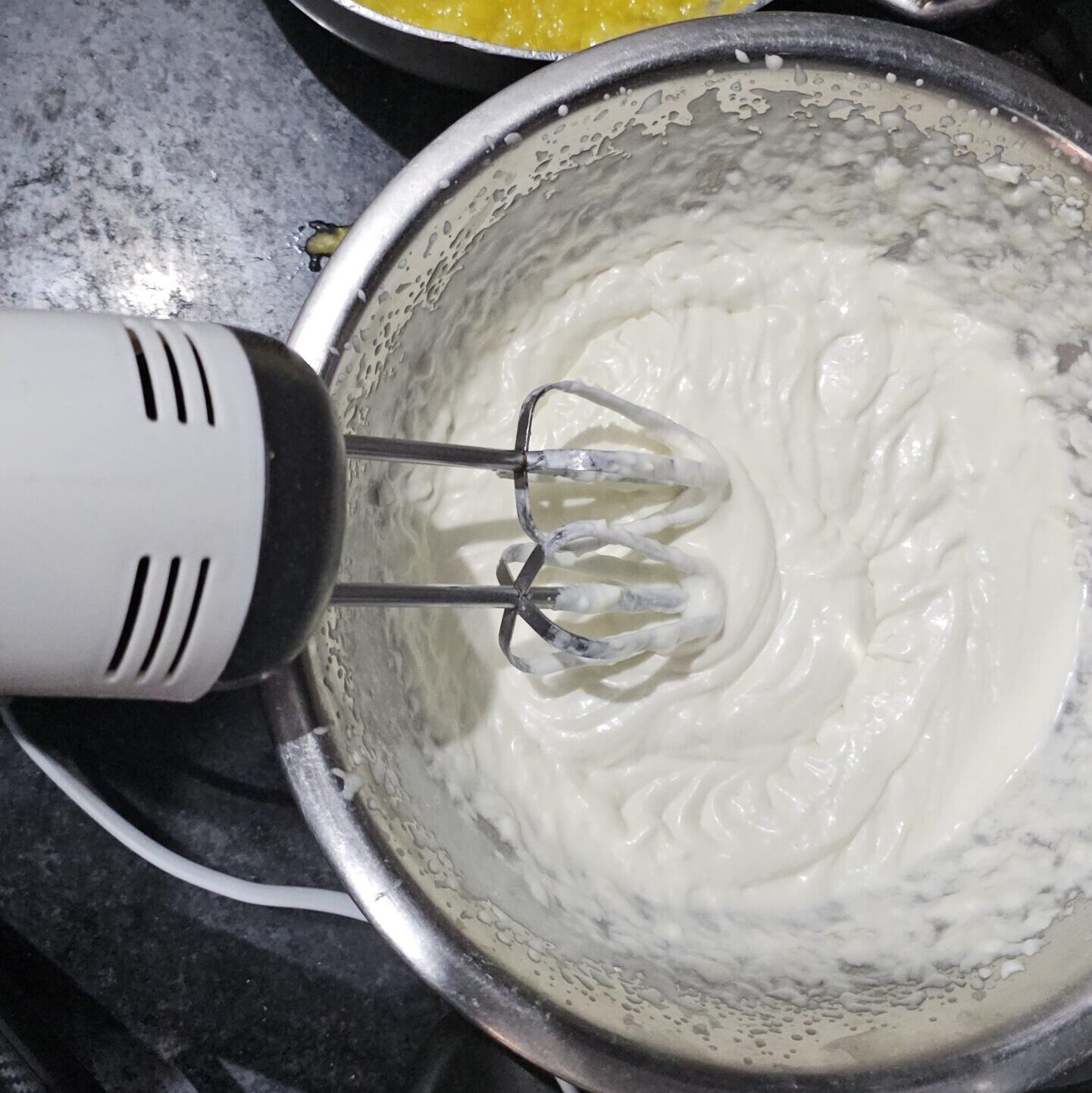 Cream cheese being mixed into whipped cream